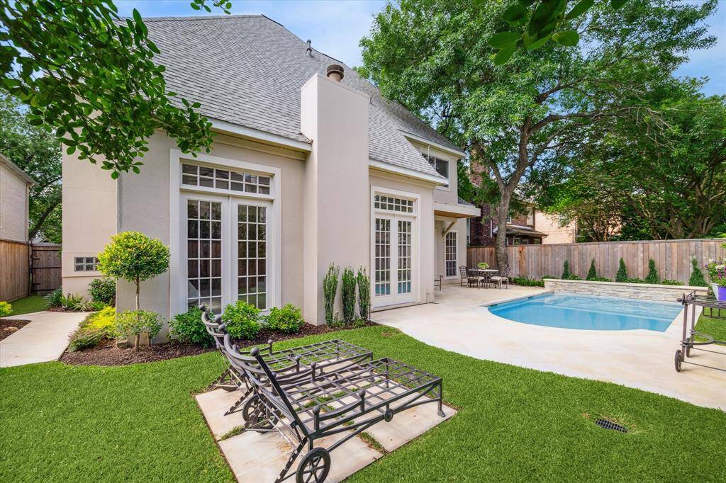 Lounge poolside or admire the lush, manicured landscaping—this backyard offers both comfort and charm.
