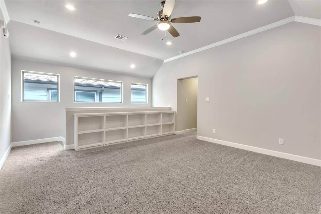 Second-floor media room with built-in bookshelves