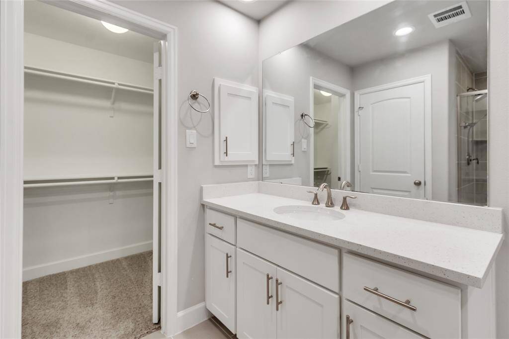 Master vanity with a view of the 2nd walk-in closet