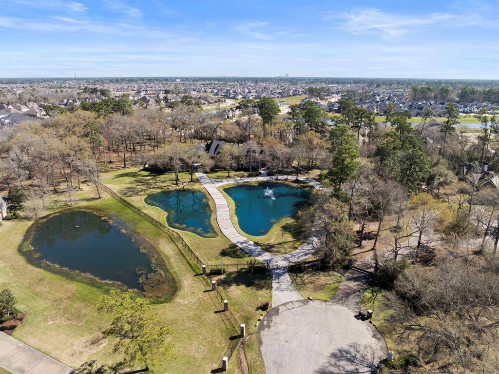 Nestled within the serene embrace of nature, this estate boasts two picturesque, well-stocked ponds, offering a tranquil oasis amid lush, carefully curated landscaping. The winding pathways meander through an expanse of verdant beauty, providing a seamless blend of elegance and tranquility. A majestic fountain punctuates the scene, adding a touch of regal splendor to this private paradise. Here, amidst whispering trees and the gentle lapping of water, one finds a sanctuary that promises both relaxation and