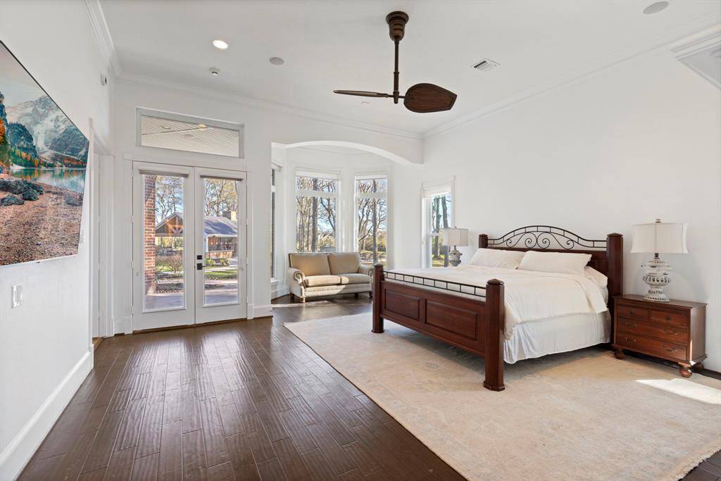 The airy primary bedroom beckons relaxation with its sophisticated decor and private patio access with a dedicated sitting area to enjoy the peaceful outdoor views.