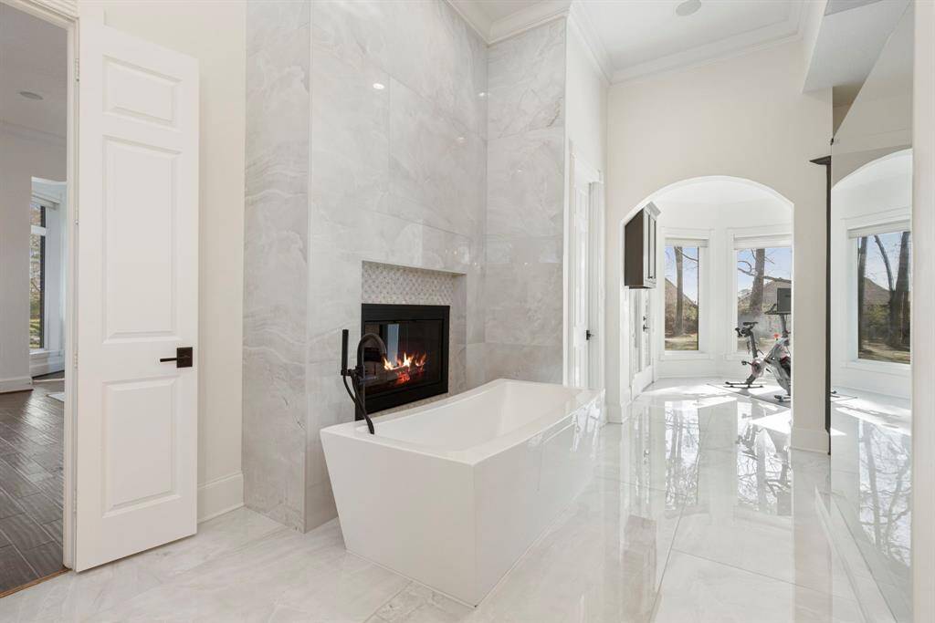 Imagine a tranquil soak by the cozy fireplace, surrounded by gleaming designer finishes.