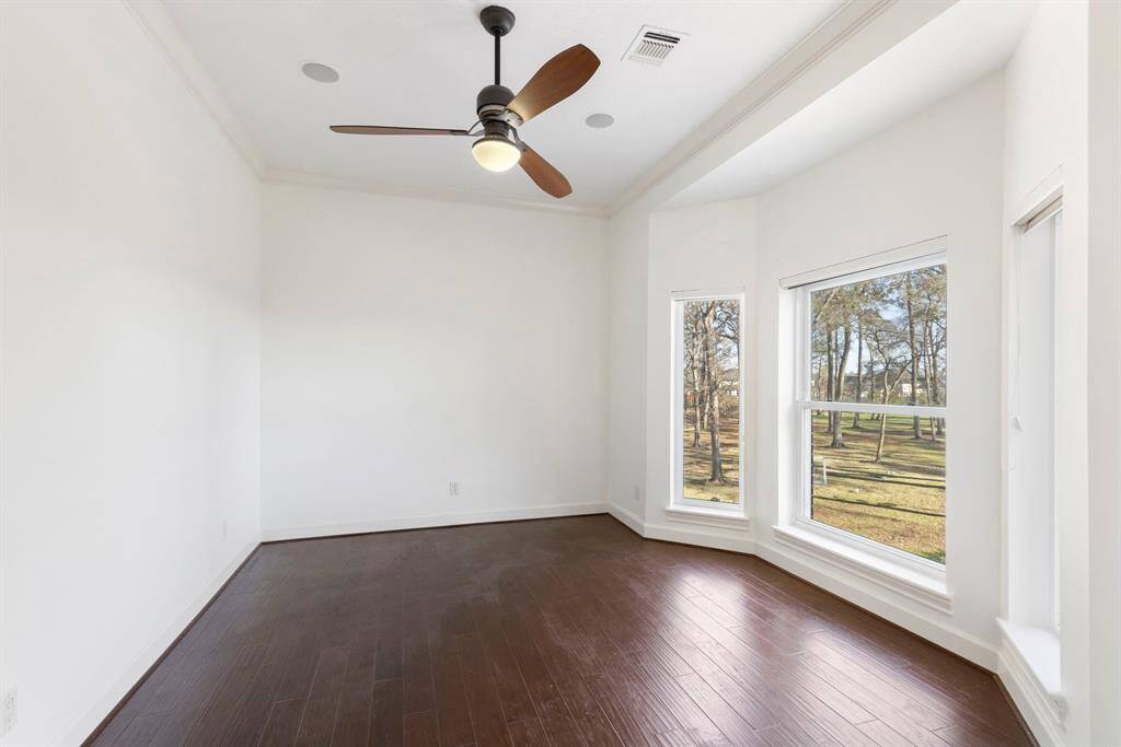 This large upstairs secondary bedroom invites endless possibilities. With views of lush greenery outside, you'll feel inspired and refreshed in your personal retreat.