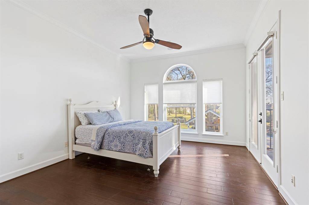From the comfort of your bed in this upstairs secondary bedroom, enjoy peaceful vistas of the meticulously landscaped grounds with your private access onto the Juliet balcony—a perfect retreat to start and end the day with nature's calming embrace.