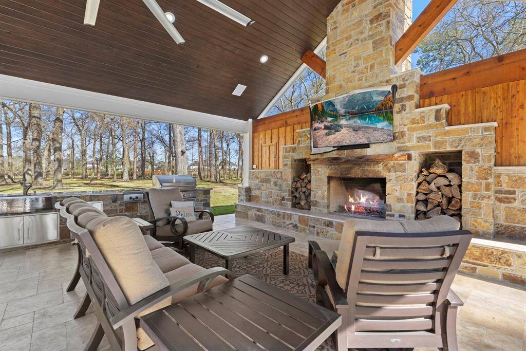 Unwind in style in this luxurious outdoor oasis, where the charm of rustic elegance meets modern convenience while you cozy up by the grand stone woodburning fireplace as you enjoy the wooded views. It's your personal retreat—where everyday chaos melts into tranquility.