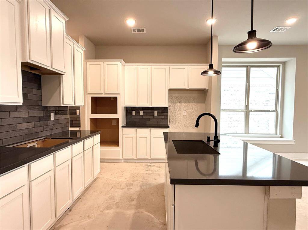 Natural light pours in through large windows, creating a bright and airy atmosphere that makes cooking feel less like a chore and more like a delightful experience.