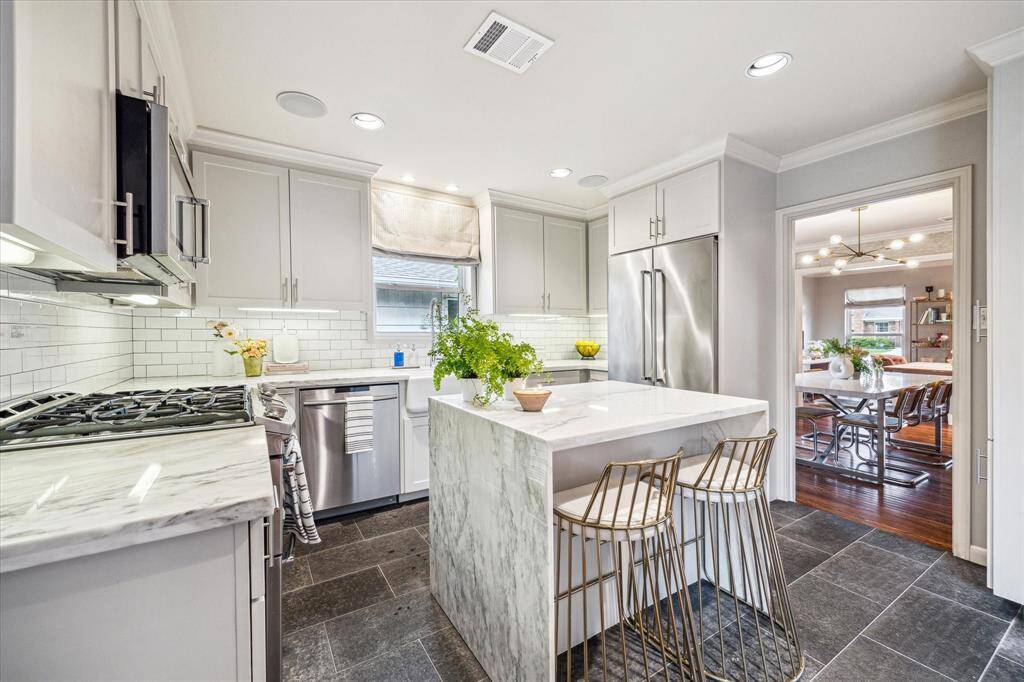 Bright Kitchen in the center of the home open to the dining room and family room.