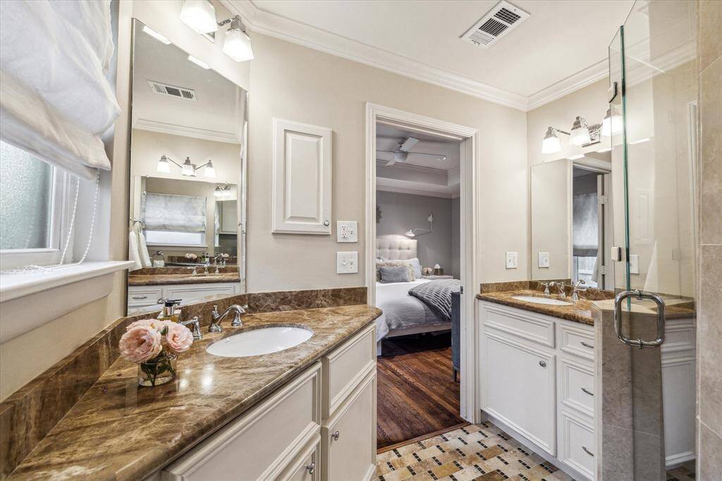 Primary bathroom with dual vanities.