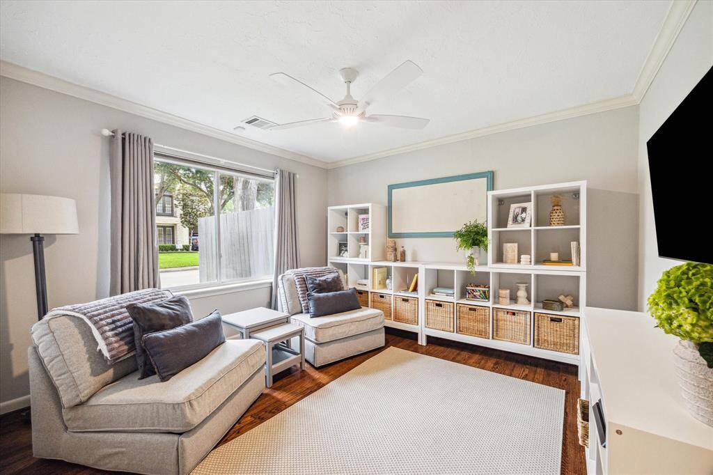 Secondary bedroom with wood flooring.