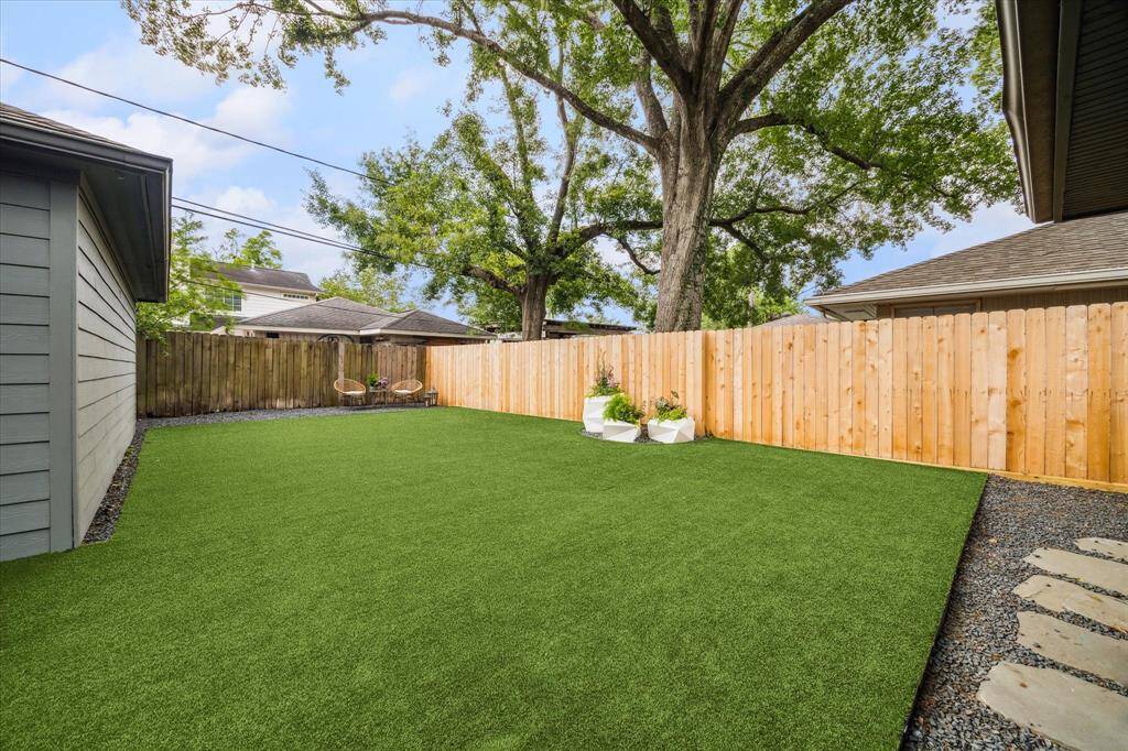 Spacious backyard with turf.