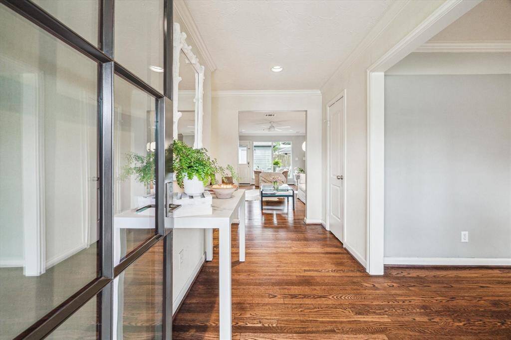 Entry with wood flooring and Designer wall paper.