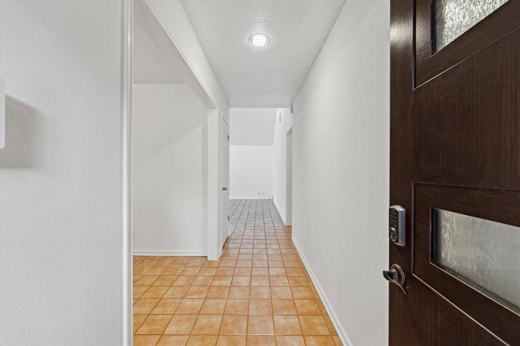 Entrance through modern door, fresh paint and saltillo-like floors!