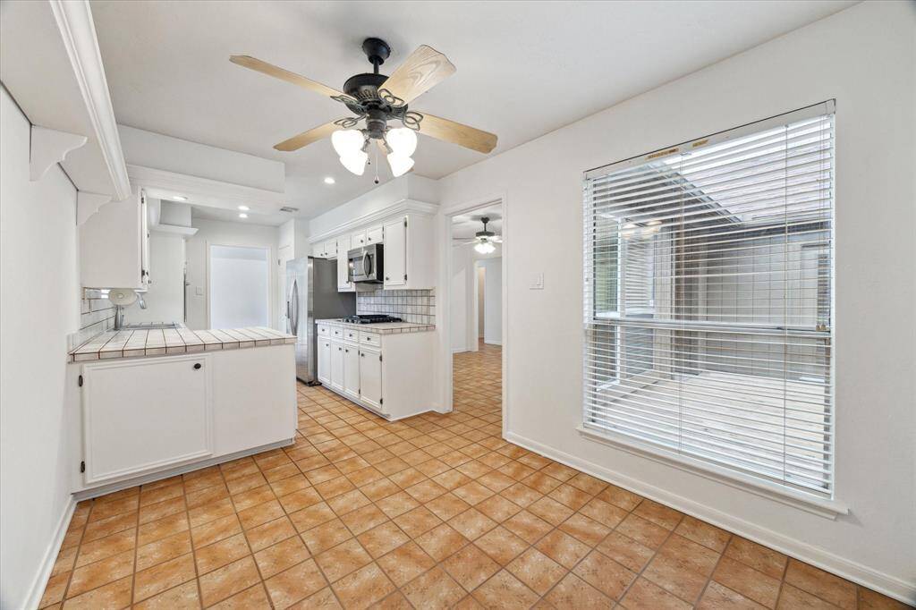 Breakfast area off of kitchen with windows and so much natural light.
