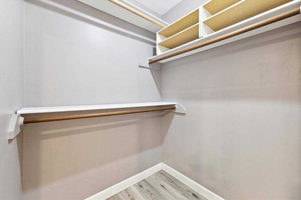 One primary walk in closet with plenty of storage space.