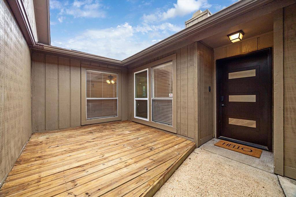 Adorable courtyard/wooden deck at front entrance.