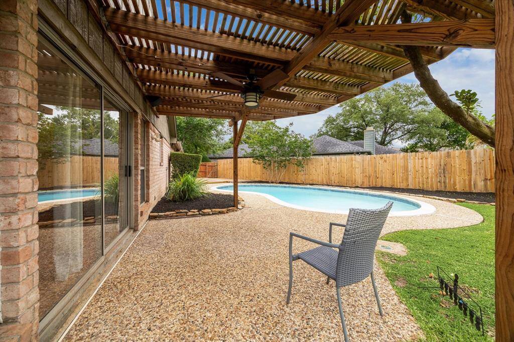 Covered pergola featuring pool with new fence!