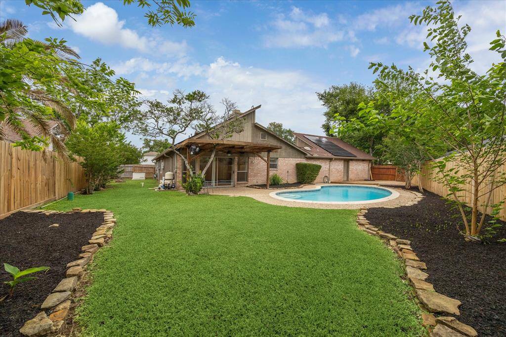 Large lot with stone edged landscaping.