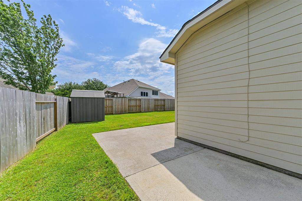 Back patio features oversize concrete pad that wraps around house