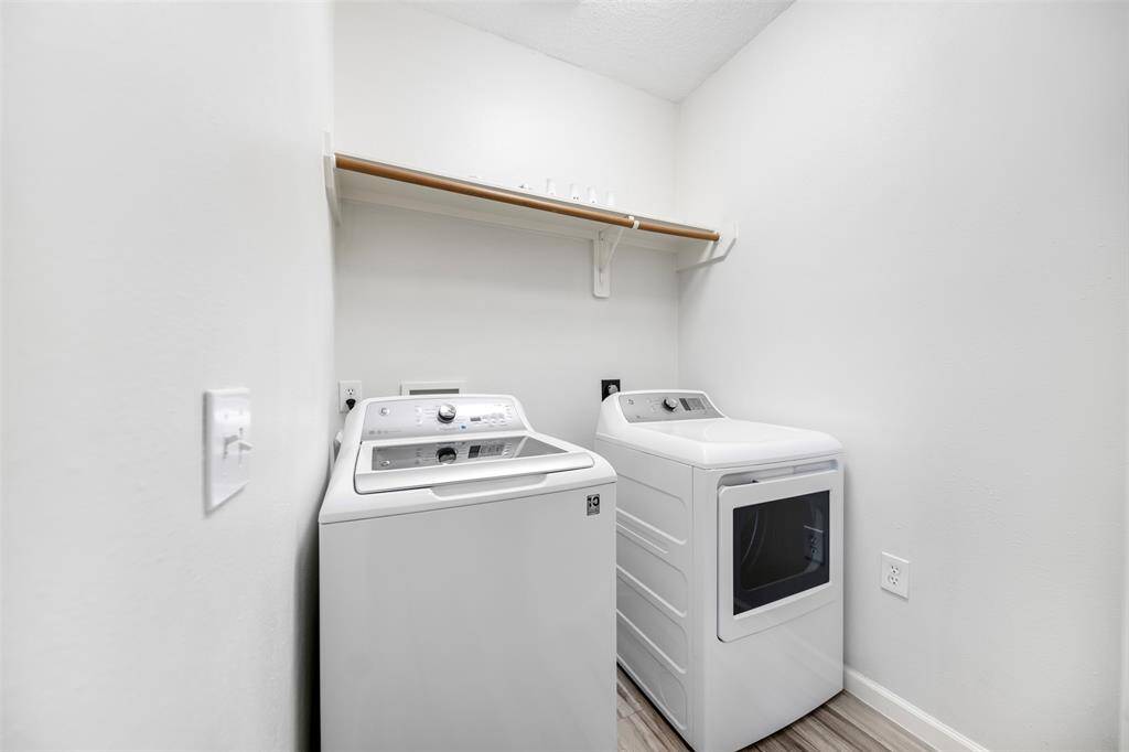 The laundry room, conveniently located just off the kitchen, offers both functionality and ease of access. With plenty of space for organization, it features modern finishes and ample storage, making laundry day a breeze while staying seamlessly connected to the heart of the home.