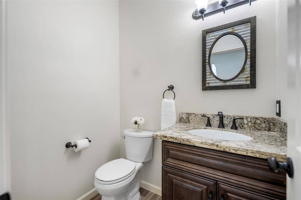 Conveniently located just off the dining and living room, this stylish half bath on the first floor offers both function and charm. Featuring modern fixtures, a sleek vanity, and modern lighting, it provides a welcoming touch for guests and everyday use alike.