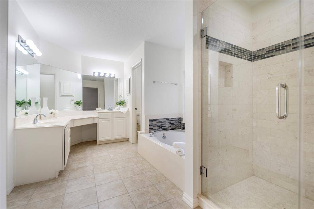 The ensuite bath exudes luxury, featuring a deep soaking tub perfect for relaxation. An updated shower adds a modern touch, while the dual vanity offers ample space and style. A separate toilet room provides added privacy, making this bath a perfect retreat for both functionality and comfort.