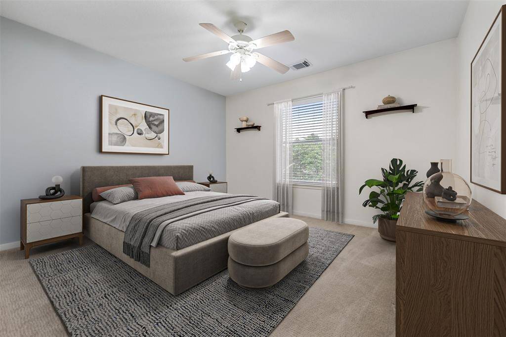 The fourth bedroom is bright and inviting, with a window that overlooks the yard, allowing natural light to fill the space. A ceiling fan adds comfort, while ample closet space ensures plenty of storage, making this room both functional and cozy. (This photo is virtually staged)