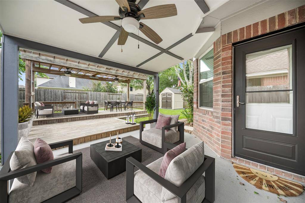 The covered patio, shaded by a beautiful wooden pergola, creates an ideal outdoor retreat. The structure provides a perfect blend of comfort and style, offering a sheltered space for dining, relaxing, or entertaining while enjoying the surrounding outdoor ambiance. (This photo is virtually staged)