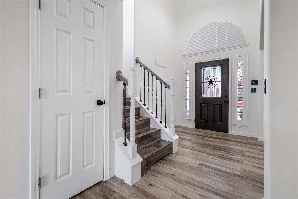 Step inside to a bright and inviting entryway where natural light highlights the elegant staircase leading to the second level. Just off the foyer, a sleek closet and cleverly designed under-the-stairs storage offer both style and functionality—perfect for keeping the space organized and clutter-free.