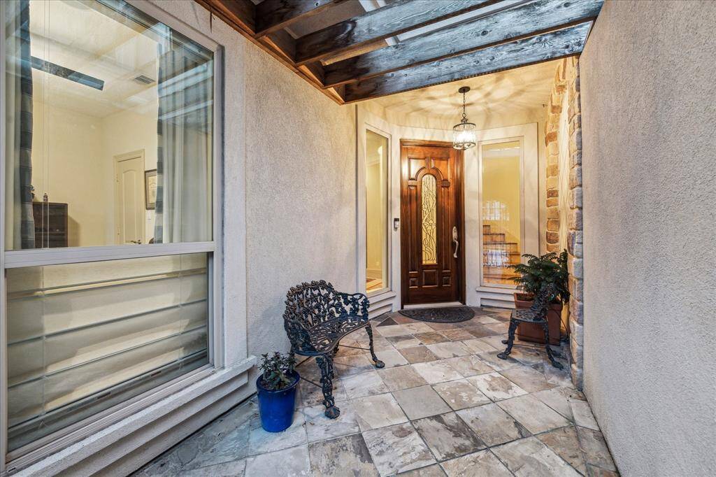 Tiled entry foyer that has wrought iron front gate (with lock) .