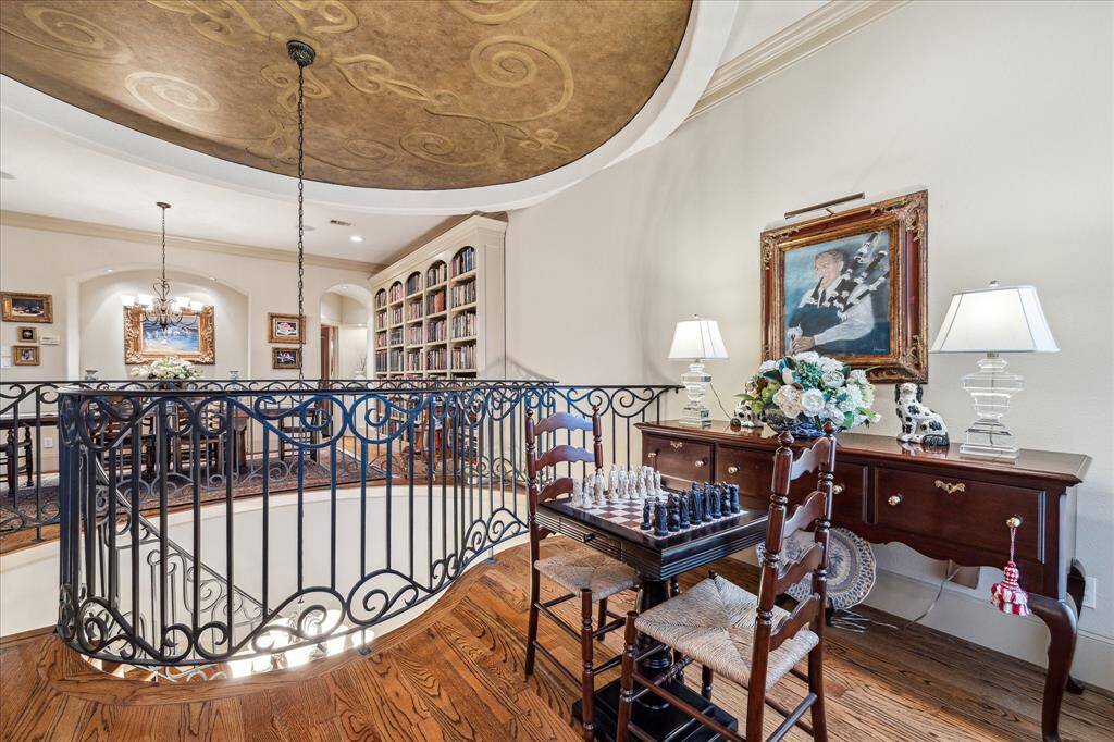 Great open living room, with abundant natural light and intricate stone surround fireplace mantel, and doors in the background leading to front Juliet balcony.