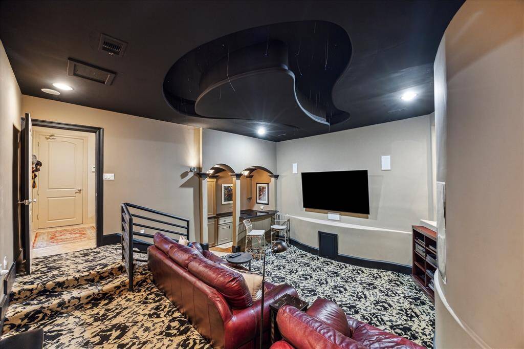 First floor theater room , fully carpeted with separate bar area (with wine cooler) and comfortable leather seating.
