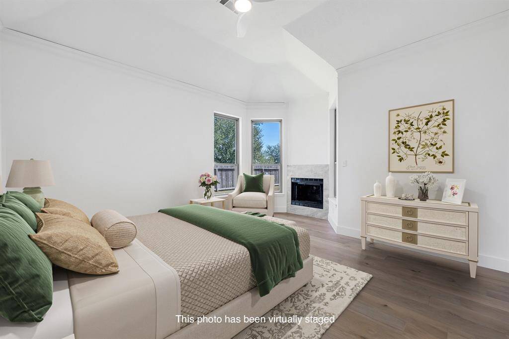 A second view of the tranquil primary suite reveals its elegant architectural lines, dual window views, and inviting fireplace—creating a private retreat just steps from the living space.