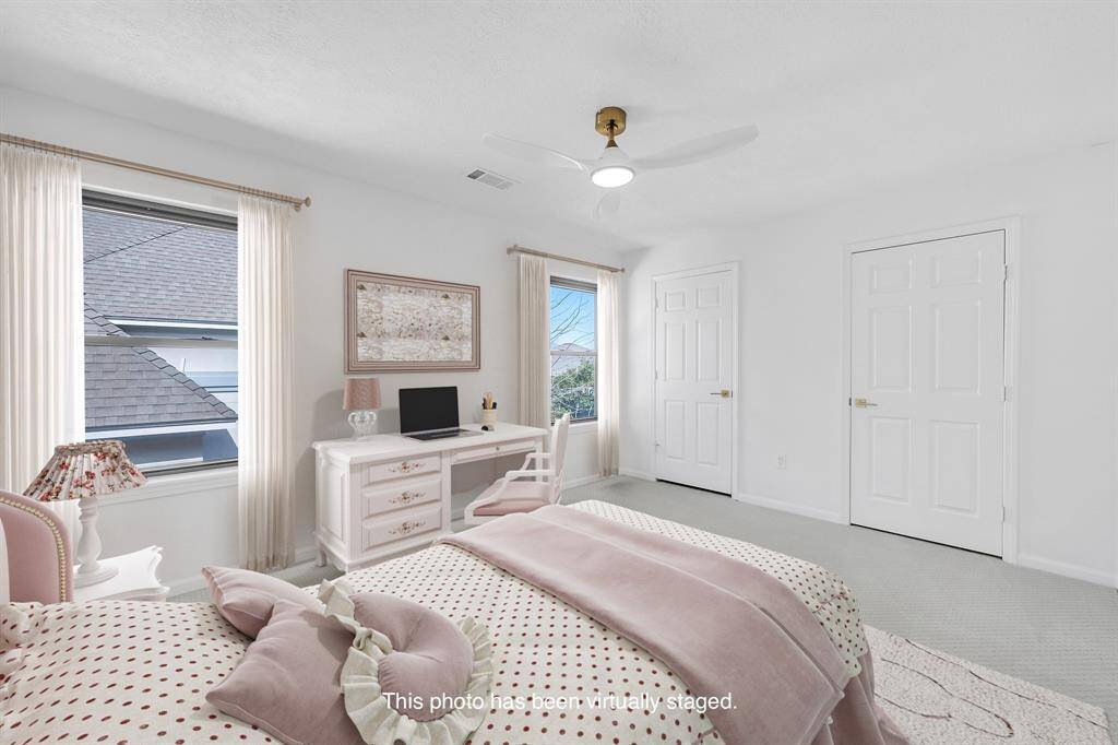 This charming secondary bedroom is virtually staged as a child’s room and features double closets and plenty of natural light.