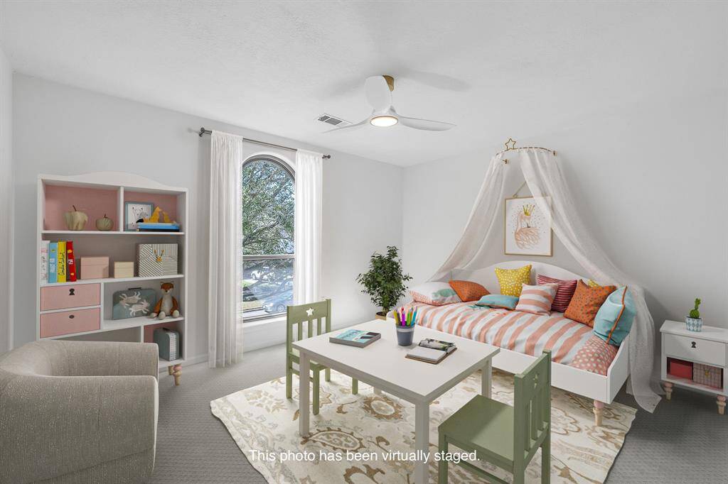 In this front facing bedroom, the arched window brings in abundant natural light, perfect for a creative retreat.
