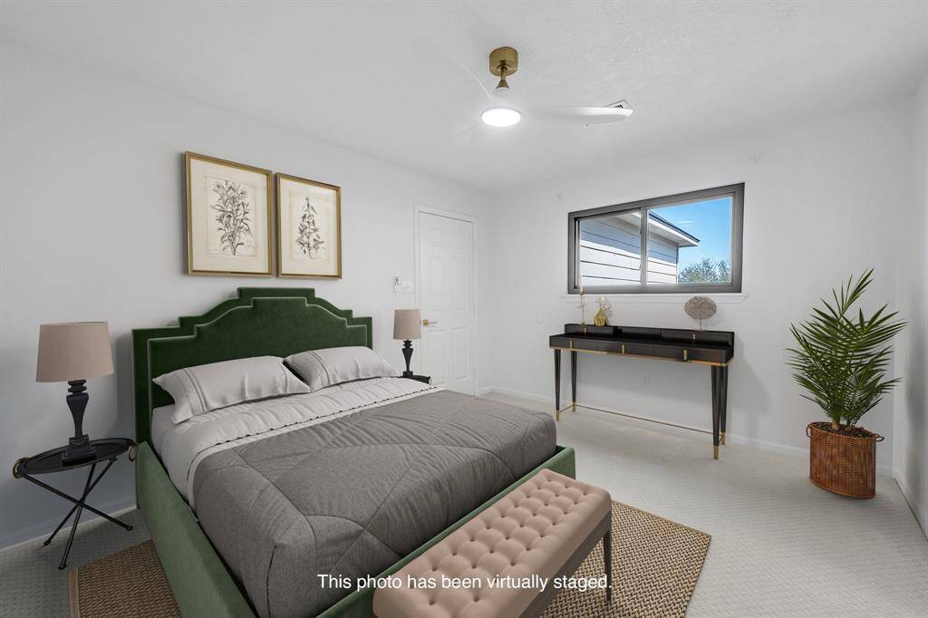 Bright and airy with carpet flooring and walk-in closet—perfect as a guest suite or teen retreat.