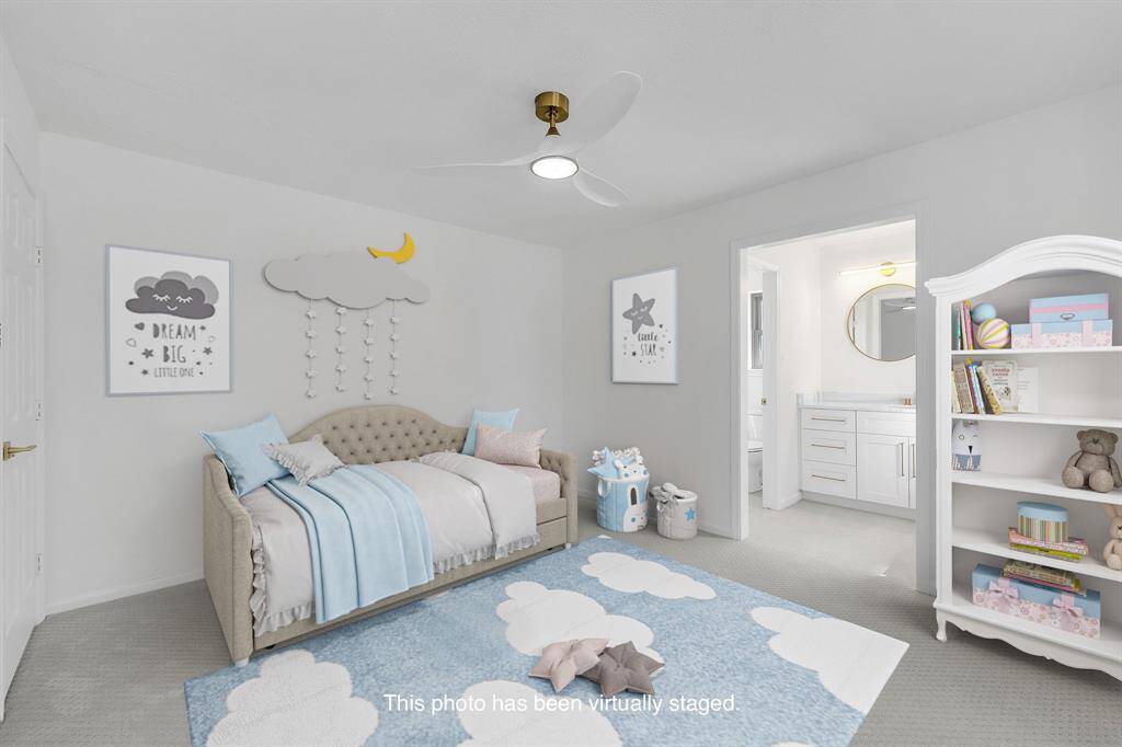 This charming room is virtually staged and has soft neutral carpeting, and an ensuite Hollywood style Jack & Jill bath.