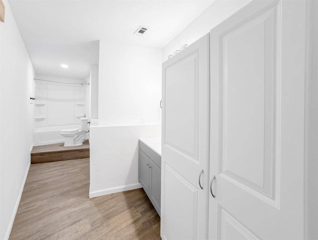 Dedicated full bathroom with walk-in shower/tub combo and spacious layout—easily accessible from the flex room or guest suite.