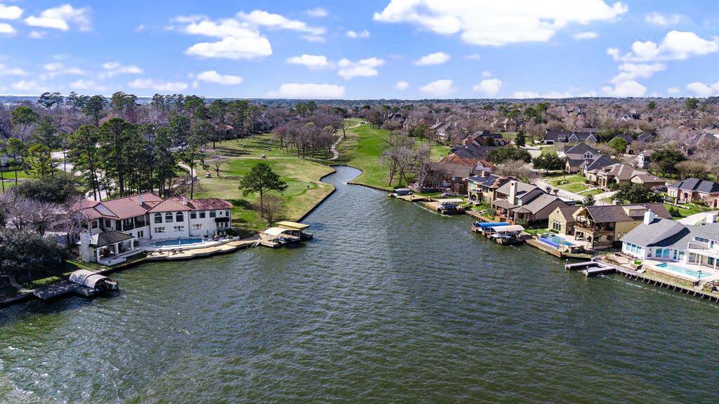 This stunning shot captures the nearby canal and golf course—highlighting the elite lifestyle and recreational access available just steps from the home.
