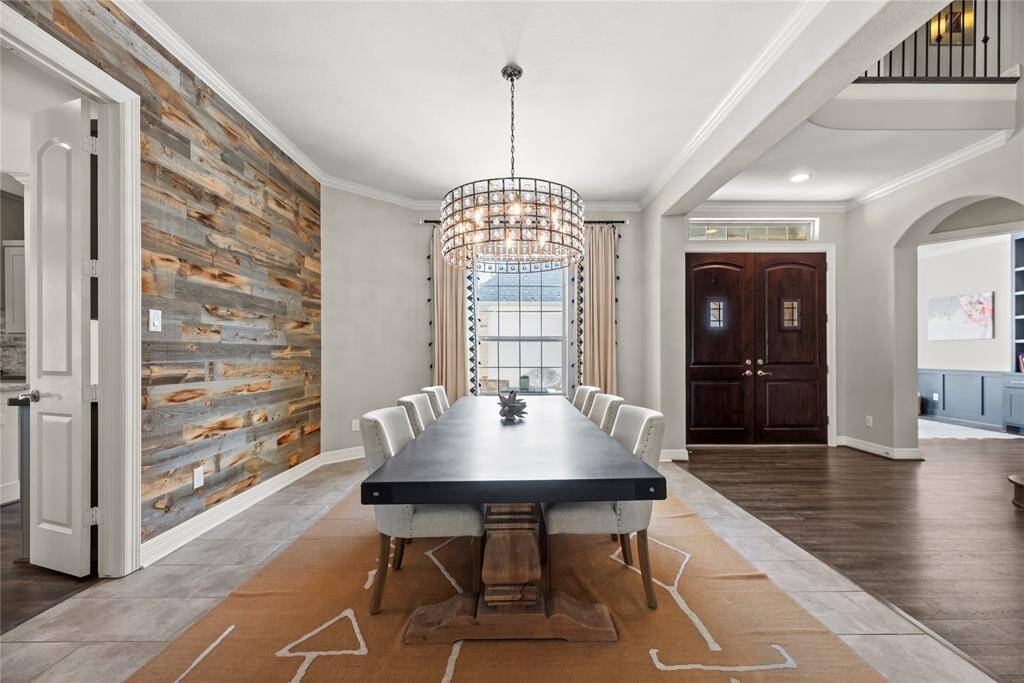 Fanciful dinners or a casual romantic dinner for two are elevated in the formal dining room. Thick white crown molding and the delicate light fixture add just the right amount of opulence for a chic dining experience.