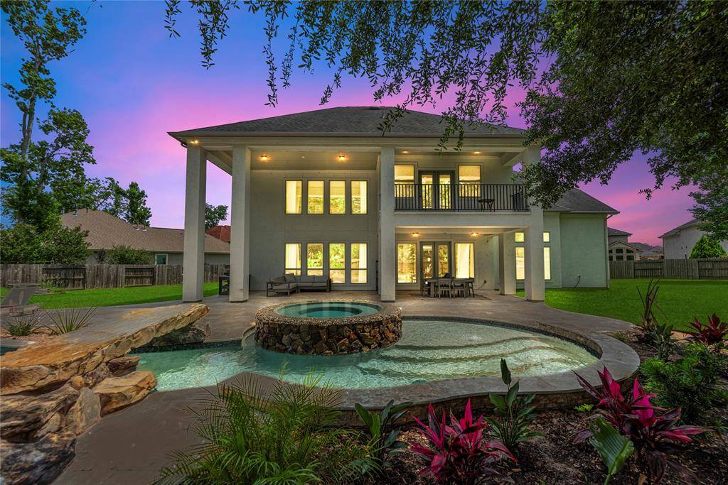 Escape to your own private paradise in this resort-style backyard, complete with a heated saltwater pool, relaxing hot tub, and a dramatic grotto with waterfall and bridge. Gather around the cozy firepit for unforgettable evenings under the stars.