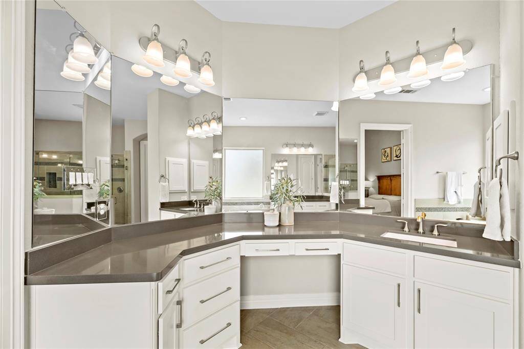 Dual sinks ensure both partners have a dedicated area for grooming and self-care! Ample counter space is only enhanced by the tremendous space beneath, which includes multiple drawers of varying sizes and base storage cabinetry!