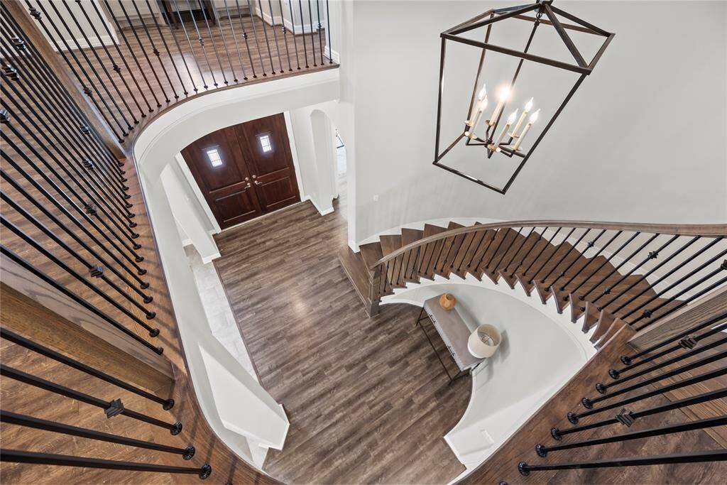 Traditional meets modern with the dazzling staircase. The deep hued banisters wonderfully complement the wrought iron spindles.