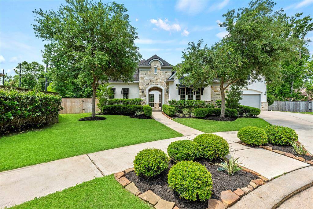 Finely crafted, the elegantly appointed brickwork entices the senses, while the charming stone-bordered flower beds add color and texture to the exterior.