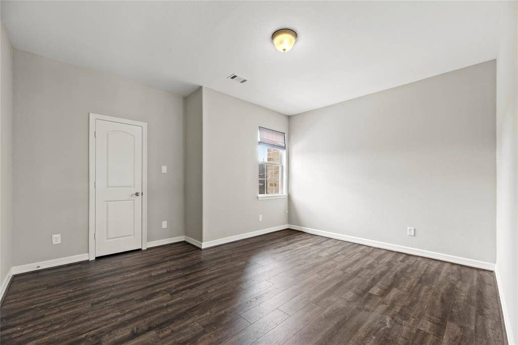 Bright white baseboards frame the bedroom, while the natural light floods in through the luminous window. Perfect as a nursery or a child’s bedroom, there is tons of room for them to stretch their little legs and play safely!