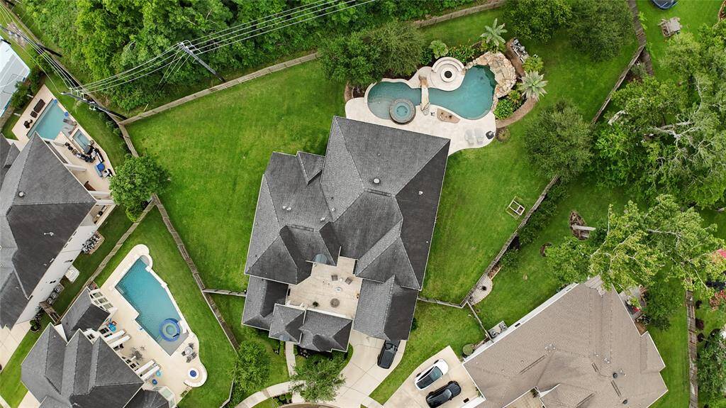 Nestled on a spacious half-acre lot, the property offers ample space and privacy surrounded by mature trees and manicured landscaping.
