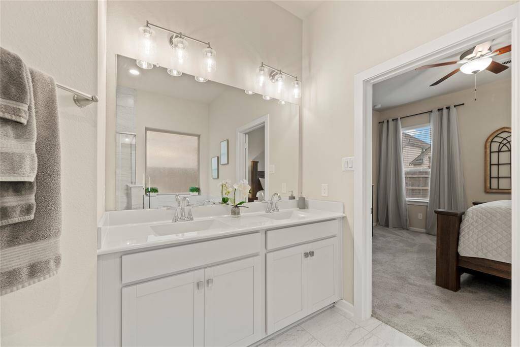 The primary bathroom offers a dual sink vanity.