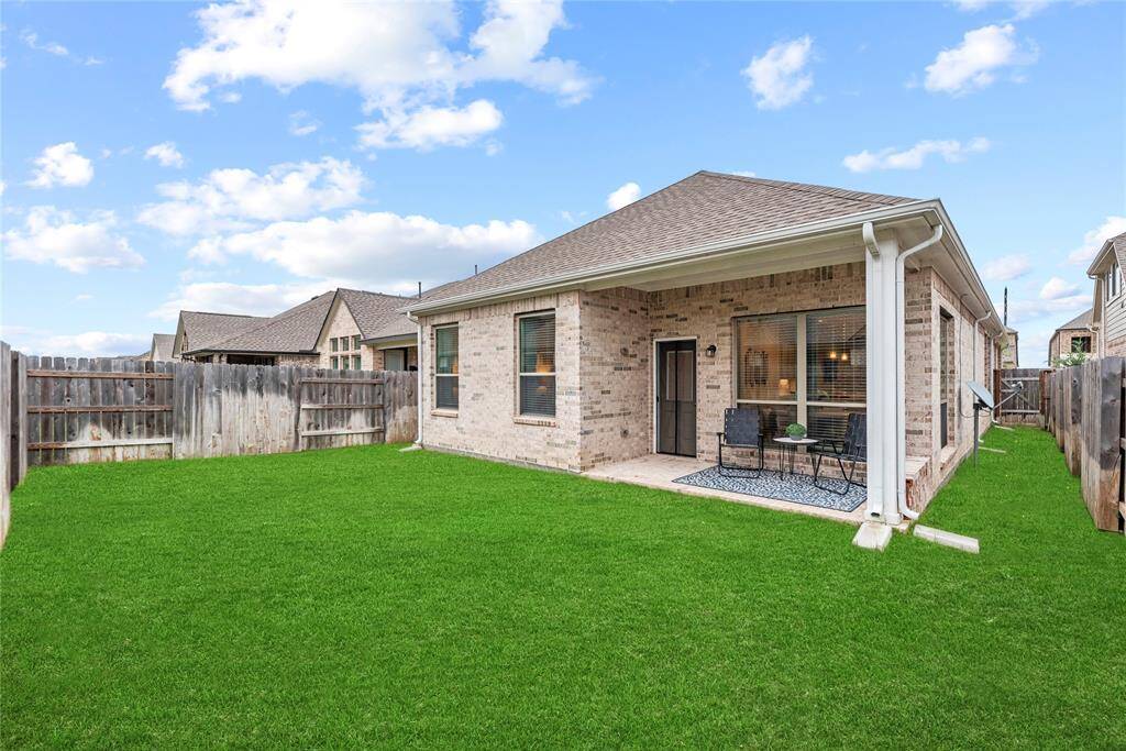 Private backyard has a covered patio plumbed for gas and wired for a tv. All 4 sides brick! Grass has been digitally enhanced to show potential.