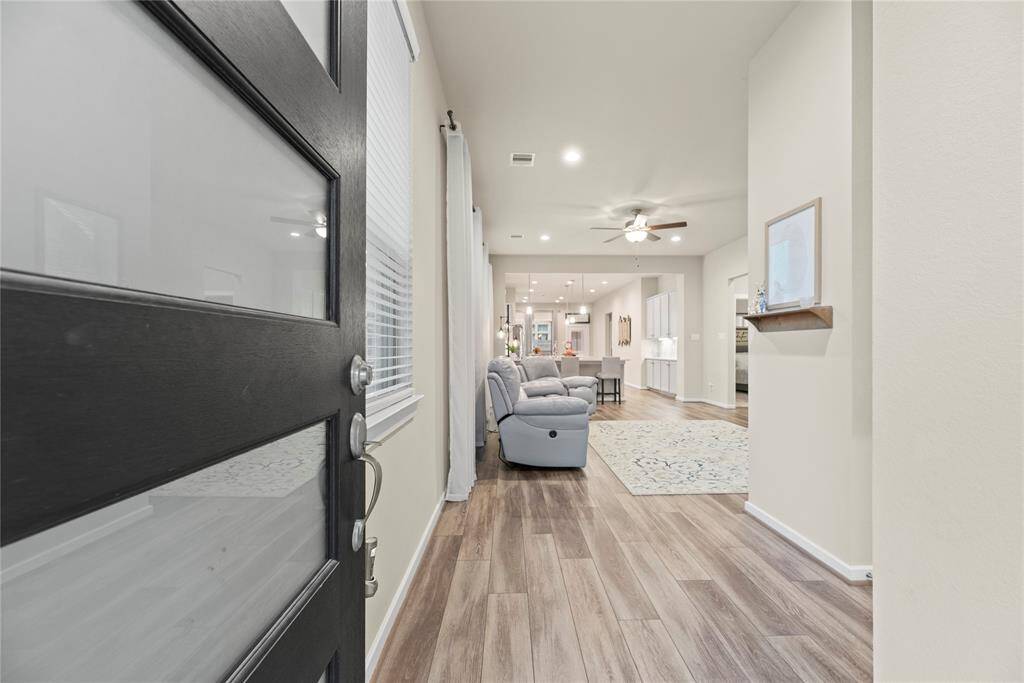 Inviting front entry with LVP flooring and neutral paint color.