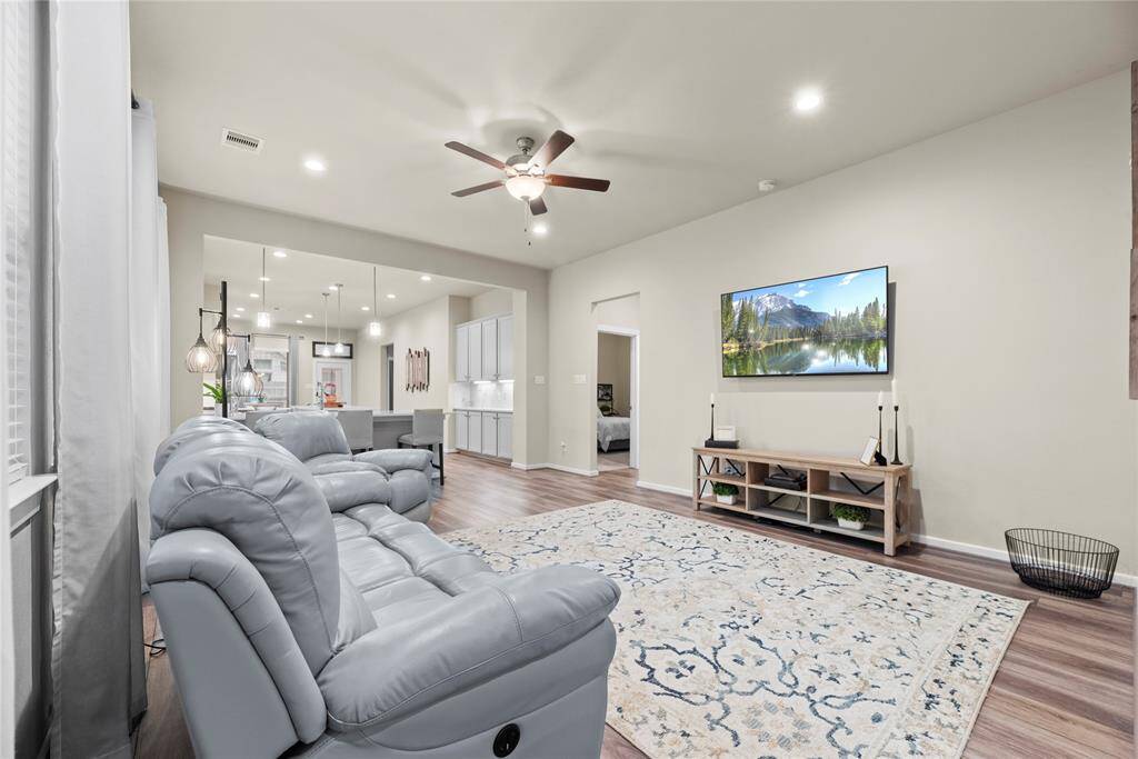 The family room boasts LVP flooring and is open to the amazing kitchen.