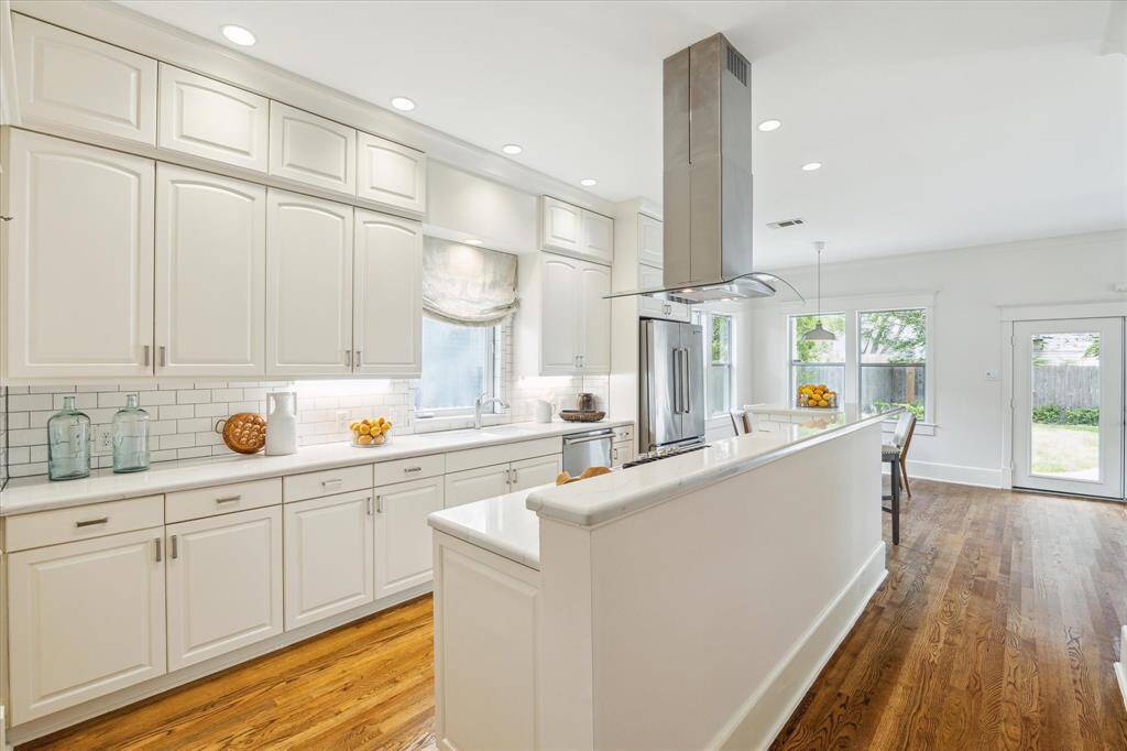 The kitchen opens to the breakfast area and den.